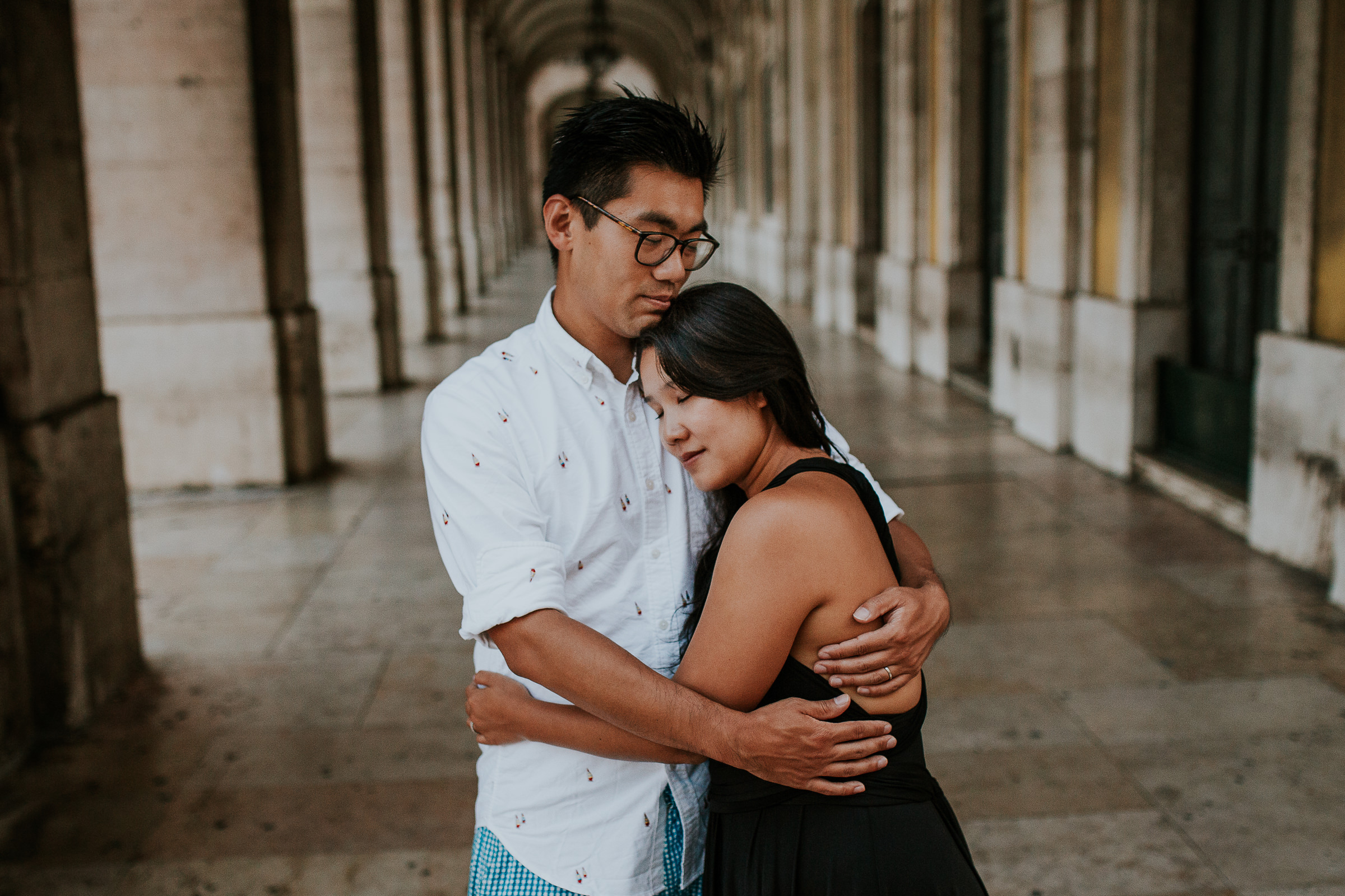 asian couple embraced in lisbon streets