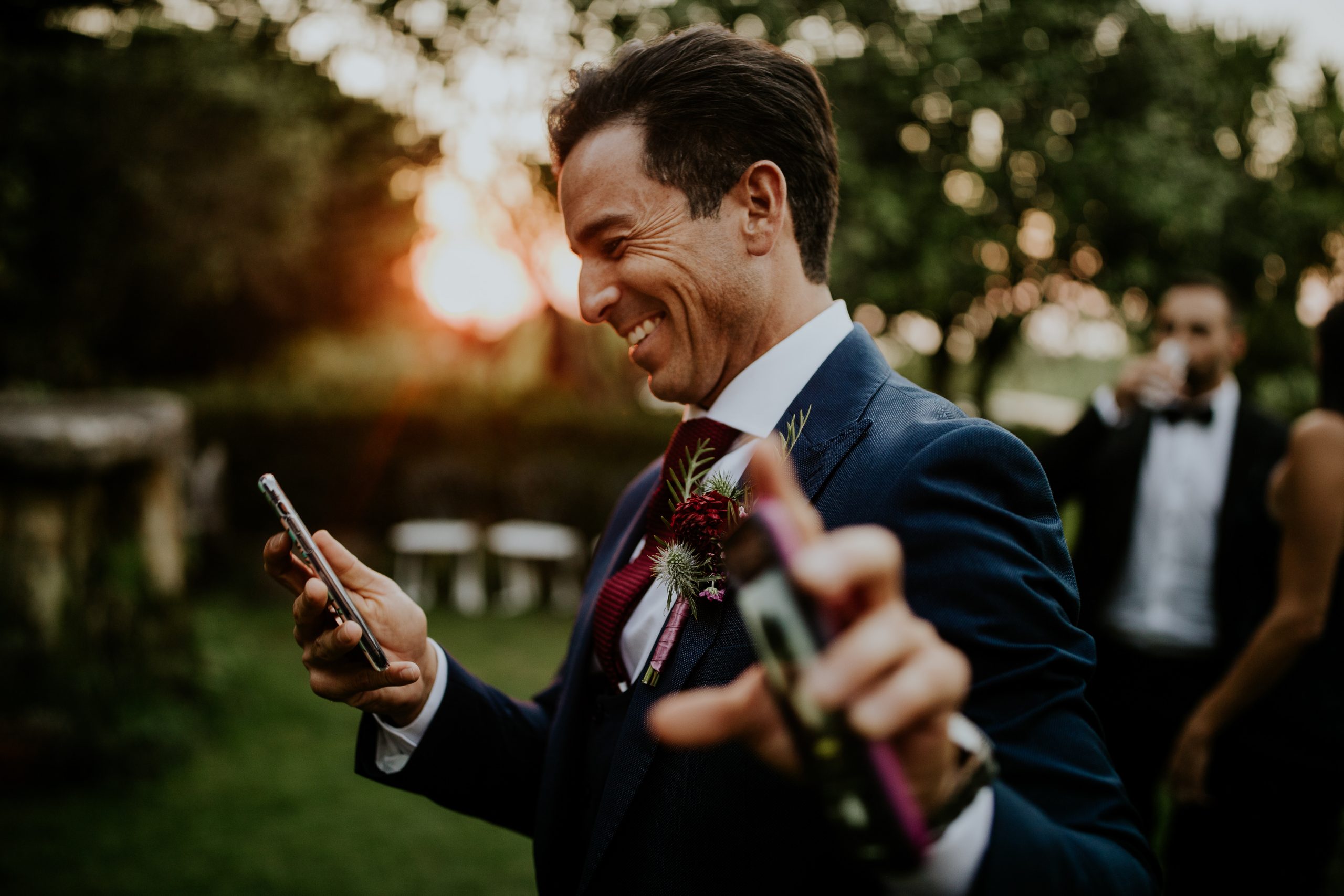 wedding guest smiling and looking at the mobile
