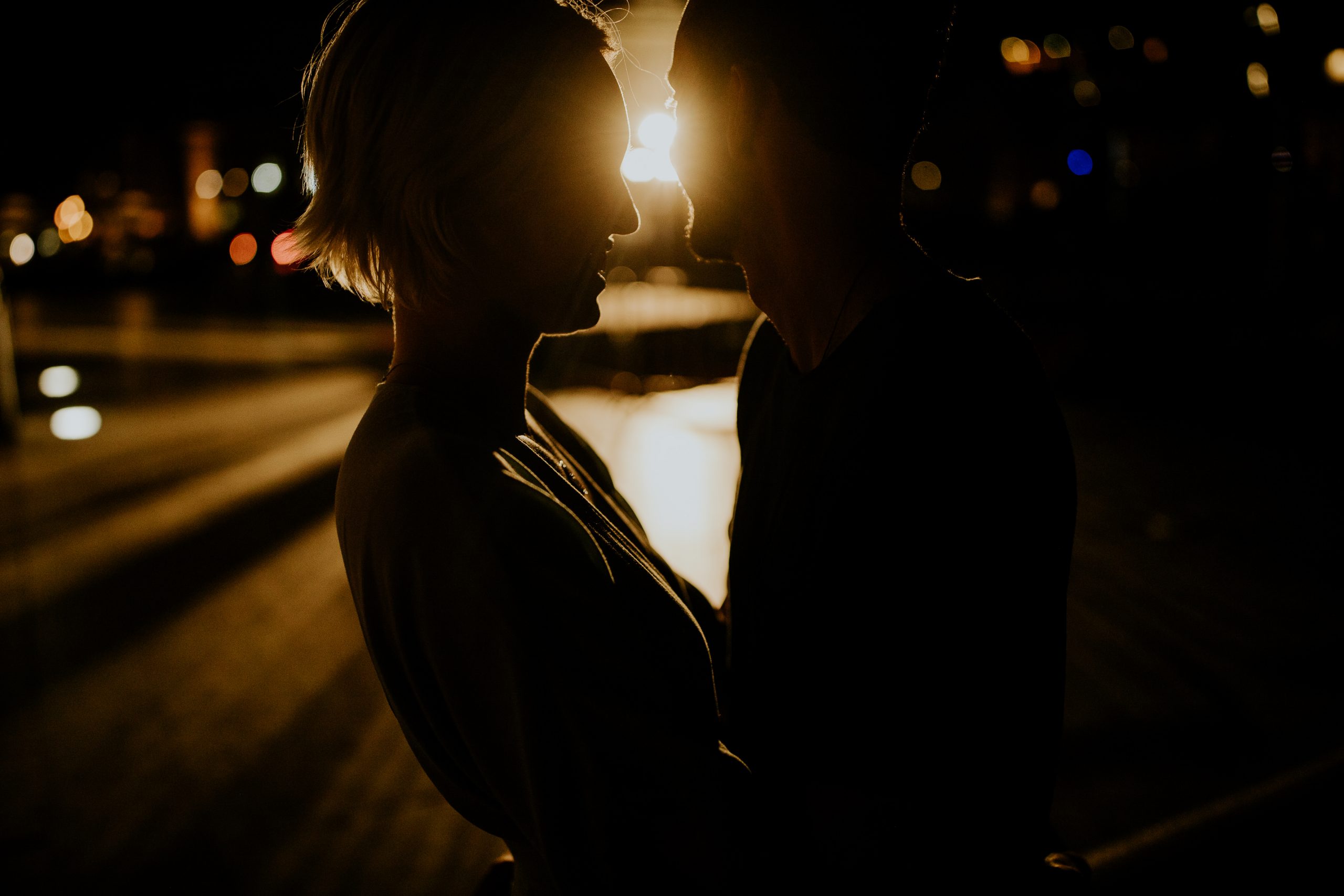 couple silhouette at night embracing and smiling