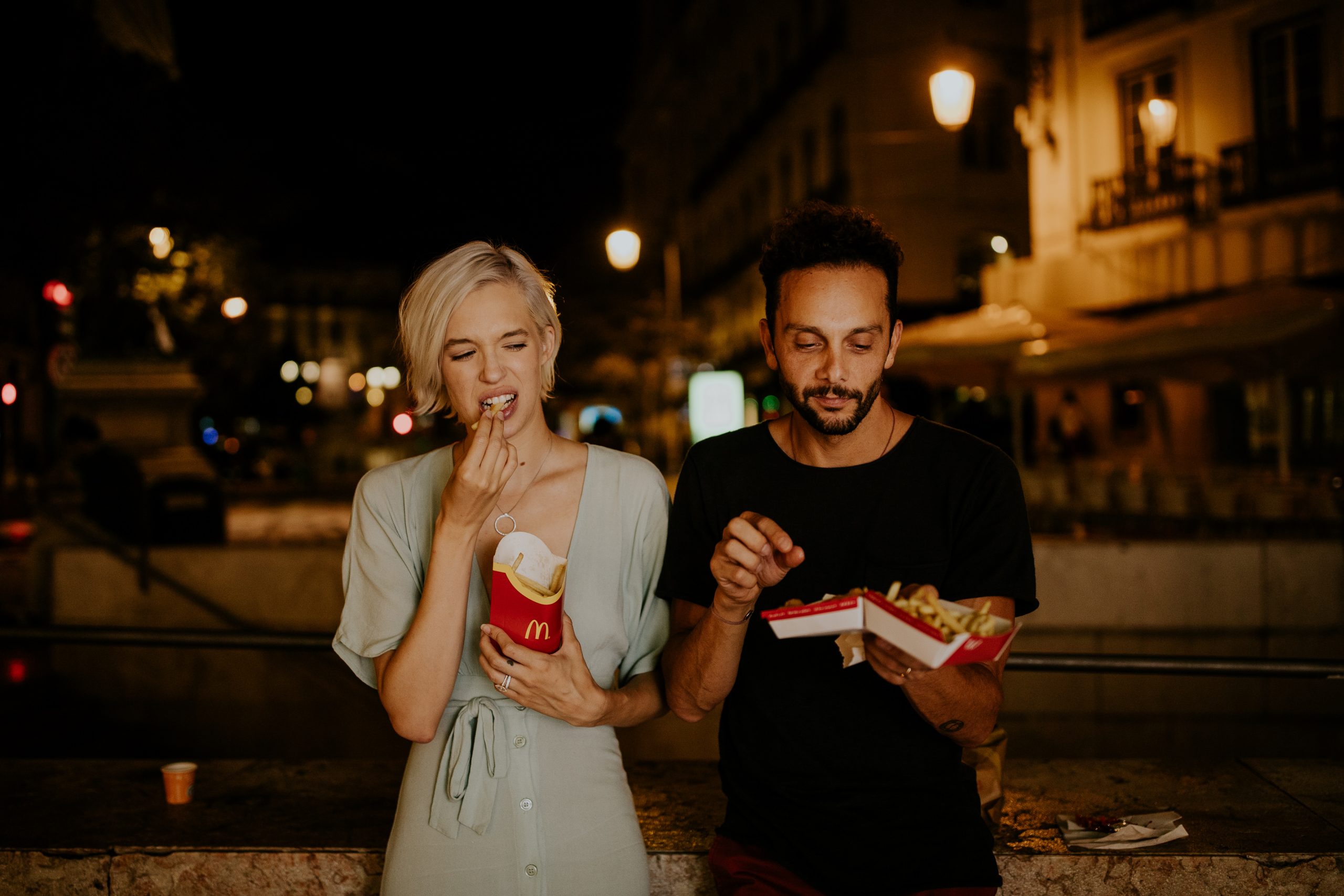boy and girl at night eating mcdonalds french fries