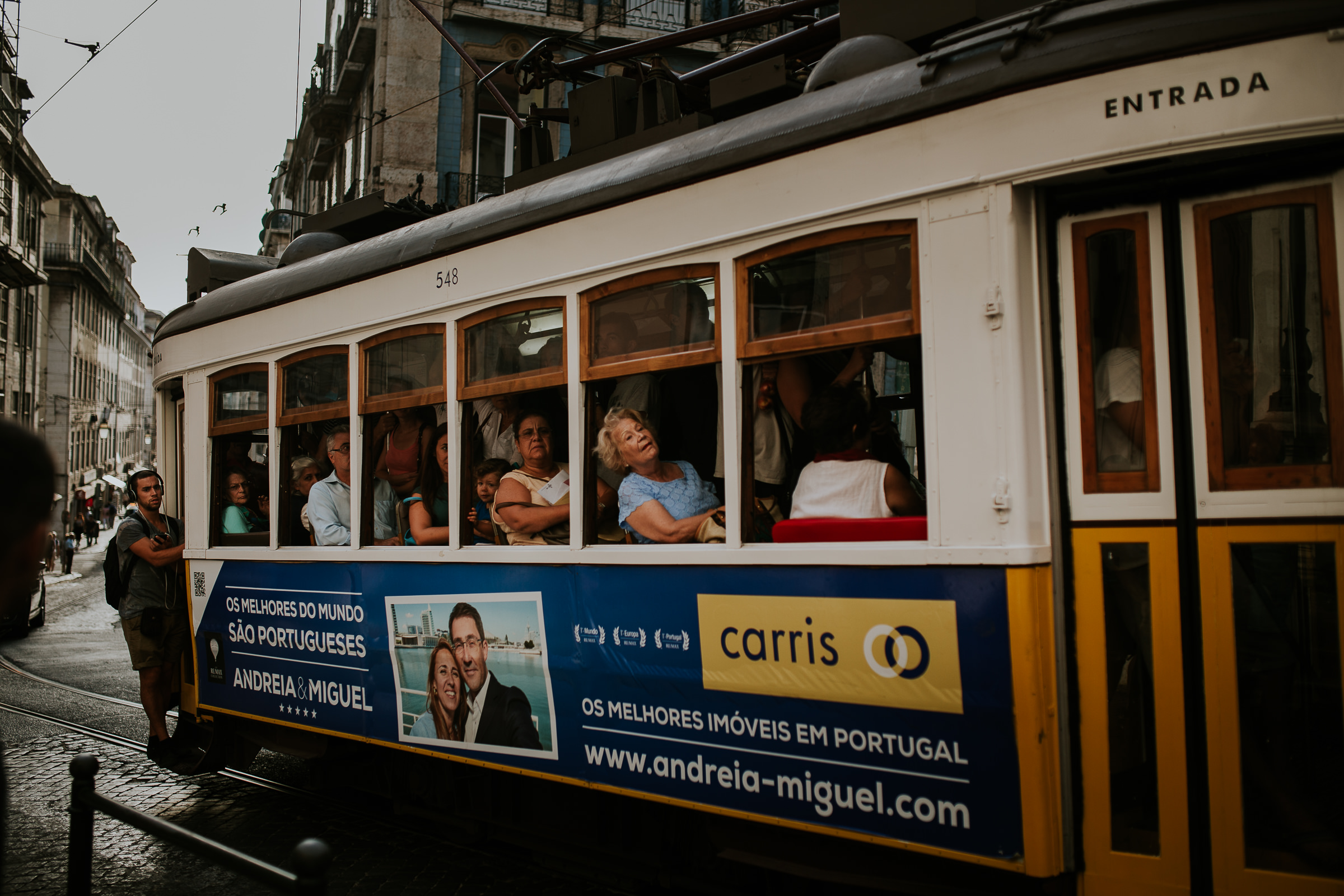 tram full of people in lisbon streets